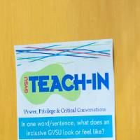 "Teach-In" flyer asking for feedback via QR-code taped to a door